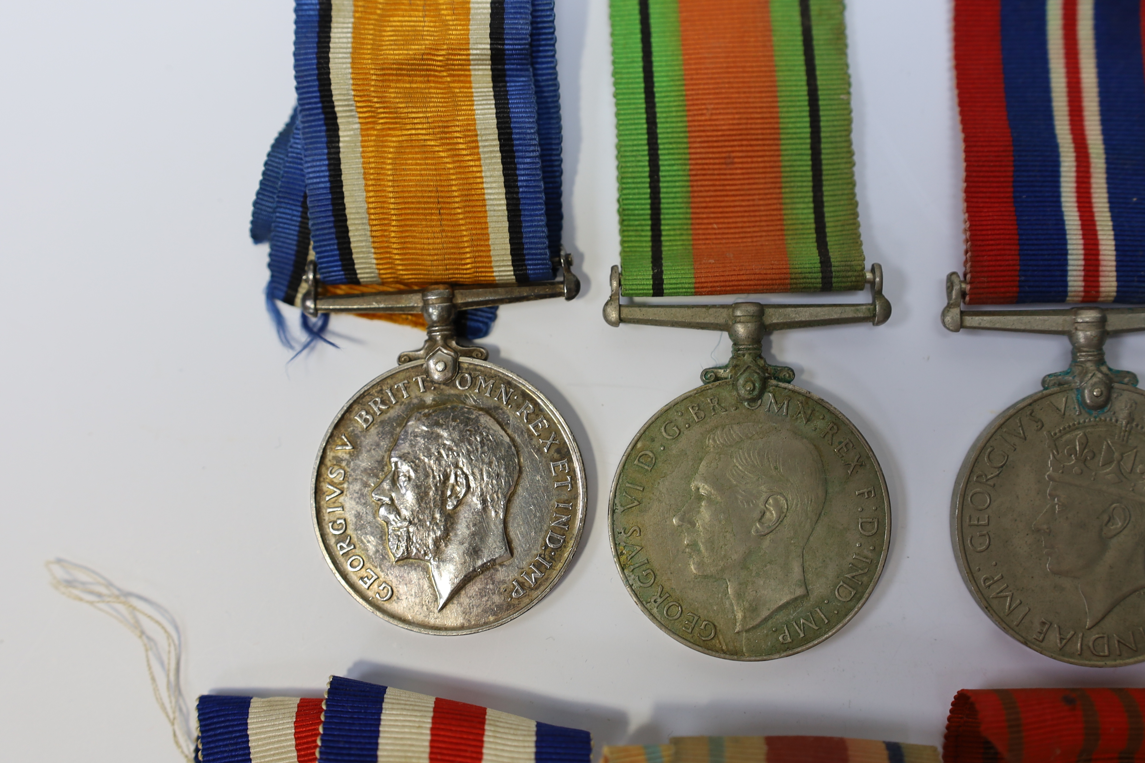 Seven medals including; a First World War British War Medal awarded to PTE. H. Lee DURH. L.I., A 1939-1945 medal, The Defence Medal, the Africa Star, the France and Germany Star, the 1939-1945 Star, plus a GPO cap badge.